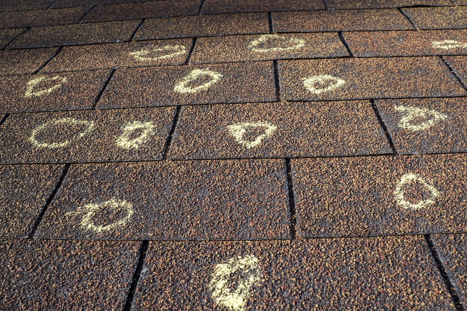 Hail damage marked on roof shingles